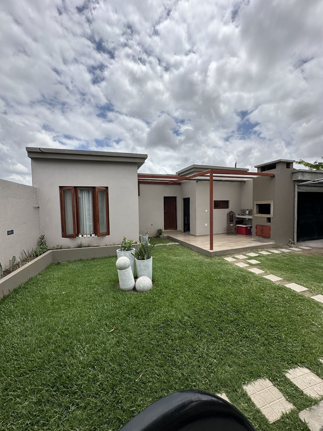 Anexo Mafurra concluída, com jardim, pérgola e churrasqueira